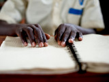 Unknown student reading Braille at the School for the Blind